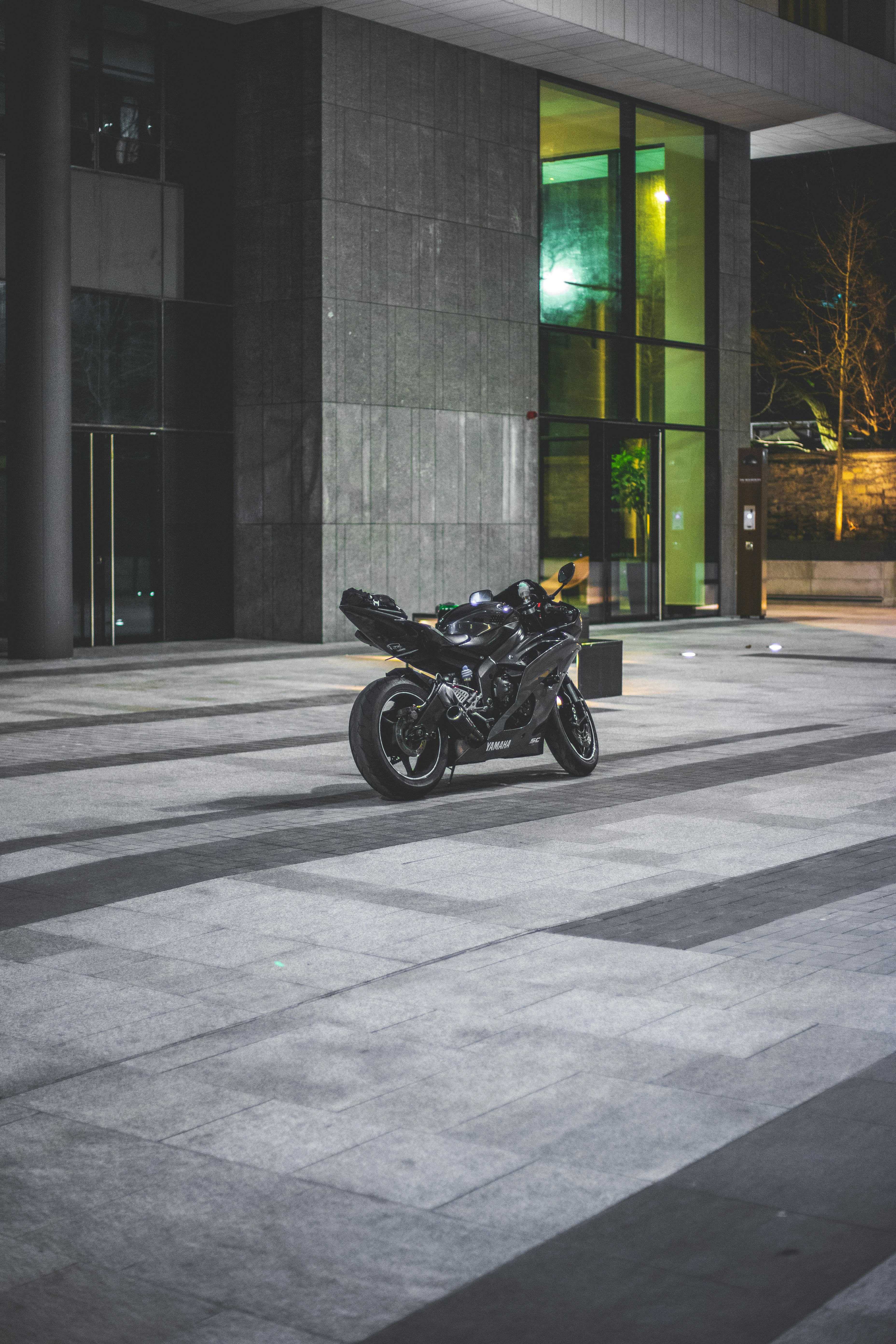 black sport bike beside building